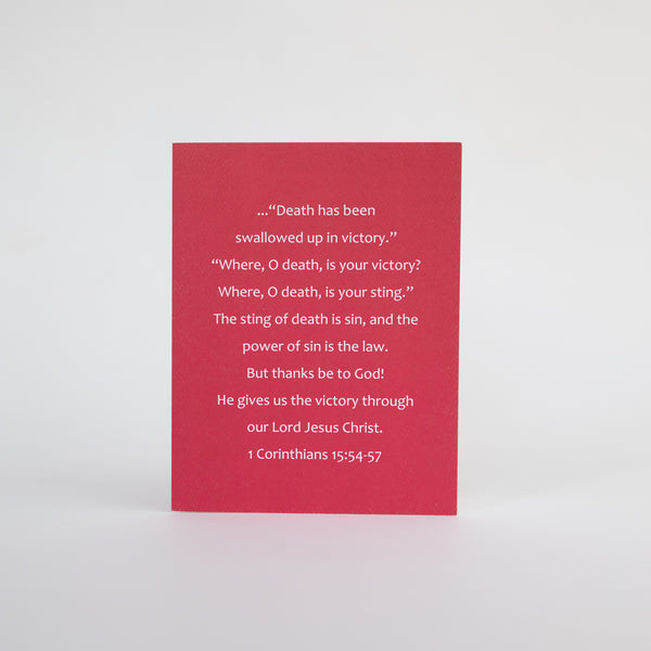 4.25 x 5.5 inch Christian Bible verse greeting card featuring 1 Corinthians 15:54-57 from the New International Version of the Holy Bible printed on Neenah Royal Sundance Cover (felt finish). Blank in the middle, additional devotional thought on the back, white envelope.